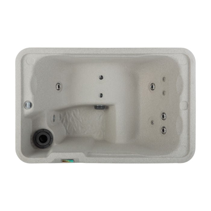 Top-down view looking into a Sand-colored Fantasy Spas Aspire hot tub, displaying the seating layout, hydrotherapy jets, filter area, and digital control panel.