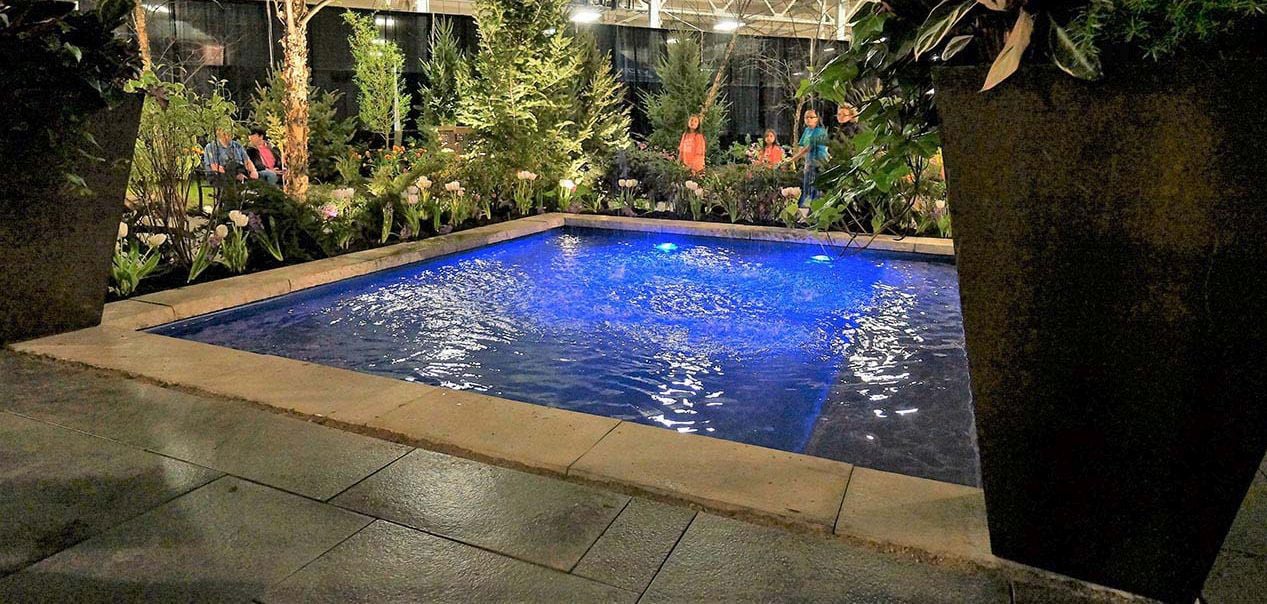 13.5' x 11.5' non-diving fiberglass wading pool with an 18-inch uniform depth, offering a spacious area for family fun and relaxation.
