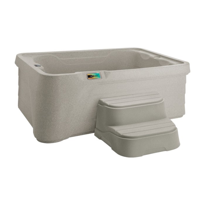 Studio shot of a compact Sand-colored Fantasy Spas Aspire hot tub featuring a digital control panel and color-matched two-tier entry steps.