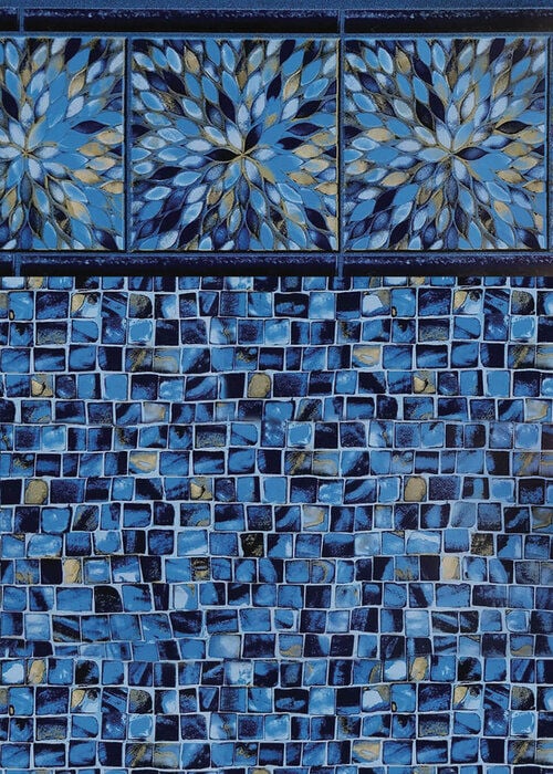 Close-up view of a vinyl pool liner pattern featuring a border of large square tiles with intricate blue and gold starburst mosaic medallions, set above a floor of small mosaic tiles in blue, dark navy, and gold accents.