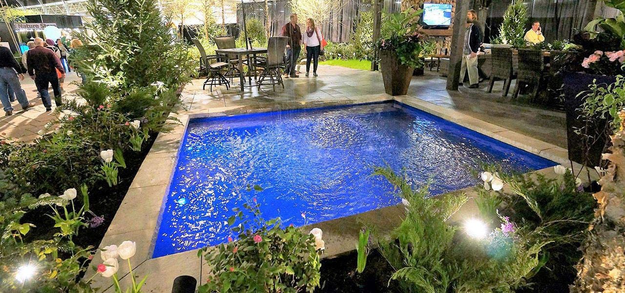 9' x 9' non-diving fiberglass wading pool with an 18-inch uniform depth, ideal for young children and backyard splash play.